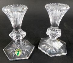 A pair of Waterford crystal candlesticks in the Chatham pattern, with paper labels, 14cm high.