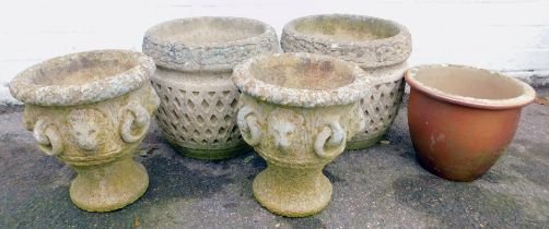 A pair of composition plant pots, of cylindrical form, cast with lion head motifs and rings, on circ