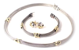 A jewellery suite, comprising two strand necklace and bracelet, in white gold with yellow gold cross