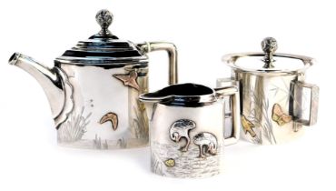 A Victorian Aesthetic influence silver three piece tea service, comprising teapot, lidded three hand