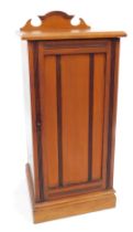 A late Victorian mahogany pot cupboard, with a carved raised back, the top with a moulded edge above