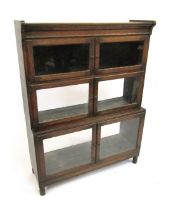 A 1920s oak sectional bookcase by Minty Limited of Oxford, with three glazed compartments, with step