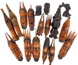 A group of African hardwood and other masks, of differing designs and sizes from Gambia, Malaysia, e