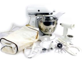 A Kitchen Aid artisan mixer, in white, together with stainless steel mixing bowl, various attachment