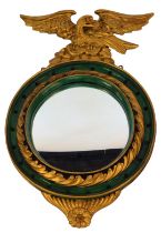 A 19thC giltwood and gesso convex mirror, of circular form, surmounted by eagle, later painted, 58cm
