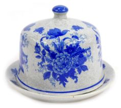 A stoneware cheese cloche and base, decorated with blue flowers against a crackle ground, printed ma