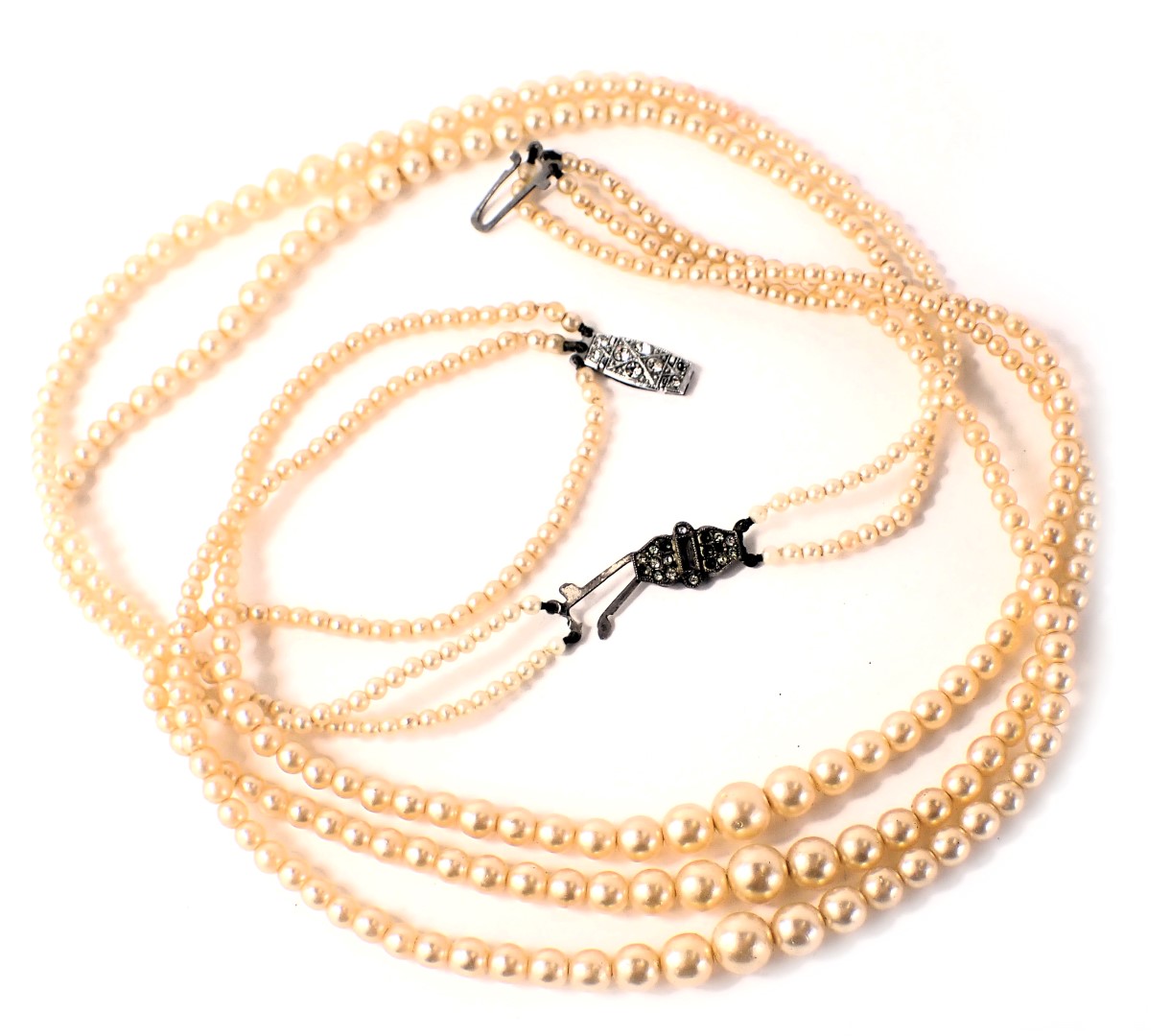 Two cultured pearl necklaces, comprising a two strand and a three strand, boxed with plated clasps.