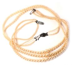 Two cultured pearl necklaces, comprising a two strand and a three strand, boxed with plated clasps.