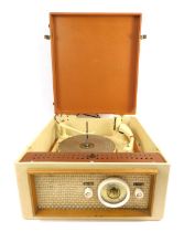 A Radio Tunetime record player, in pale brown and cream case, 38cm wide.