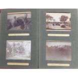 A photograph album containing early 20thC photographs in India, to include figures with guns before