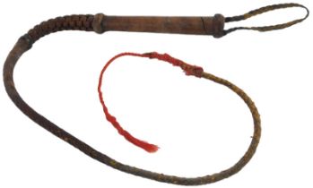 An aboriginal leather stock whip, with braided leather whip, approx 80cm long. Provenance: acquired