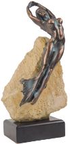 A 20thC bronzed figure modelled as a nymph, mounted on a section of hardstone, on a hardwood rectang