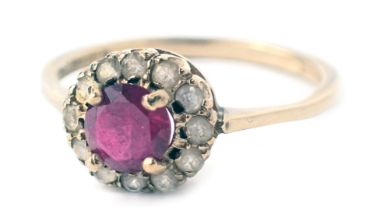 A 9ct gold floral cluster ring, set with garnet and cz stones, ring size M½, 1.6g all in.