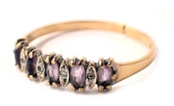A 9ct gold dress ring, set with amethyst and cubic zirconia in claw setting, on a yellow metal band,