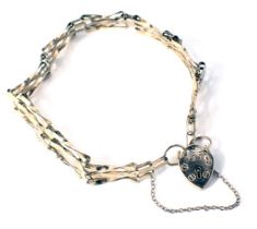 A 9ct gold three bar gate bracelet, with safety chain heart shaped padlock, 16cm long, 4.9g.