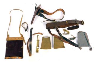 A group of military related items, to include leather belt with gun holder, and further leather belt