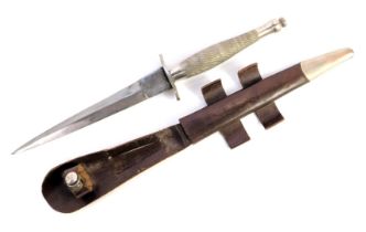 A Fairbairn-Sykes fighting knife, with cross hatched handle, the blade marked Wilkinson sword, in le