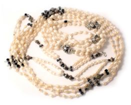 Four cultured pearl jewellery items, comprising two necklaces and two bracelets, each with black met