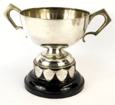 A George V silver two handled trophy, of cylindrical form, with shaped handles on stepped circular b
