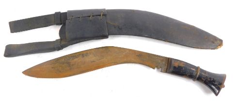 A kukri knife, with wooden handle, 41cm long in total, in leather case.