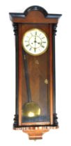 A walnut and ebonised cased Vienna style wall clock, the cream enamel dial bearing Roman numerals, e