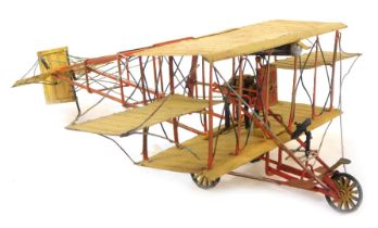 A scratch built tin plate bi-plane, in cream and red, 47cm long.