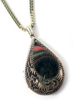 A 9ct gold locket pendant and chain, the locket of floral design in teardrop form, 3cm high, on curb