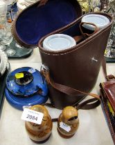 Two nesting dolls, together with a pair of cased binoculars, Torquay ware chamber stick decorated wi