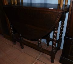 An oak gate leg table, together with a glazed two door display cabinet. (2)