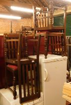 A set of four oak dining chairs, each with a slatted back above turned legs with drop in seats. The