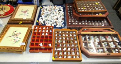 A large quantity of porcelain thimbles, some contained in collectors cases, together with pictures,