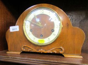 A walnut cased mantel clock, the circular style bearing Arabic numerals, eight day with Westminster