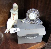 A Waterford Crystal mantel clock, boxed, together with a Nao figure of a seated clown. (2)