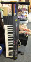 A Yamaha PSR3 electric keyboard, and stand, lacking lead.