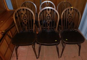 A set of six oak wheel back dining chairs. (4 + 2)