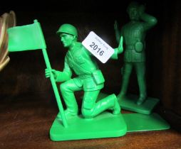 A pair of moulded green plastic Toy Story bookends, modelled as American soldiers.