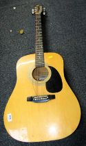 A Falcon acoustic guitar, model number FG100N.