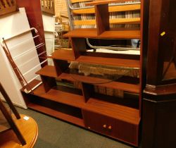 A 20thC sectional wall unit, various recesses, 144cm high, 156cm wide, mirror and clothes horse.