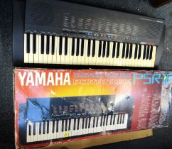 A Yamaha electric keyboard, PSR-18, boxed.