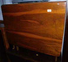 A mid century walnut drop leaf table.