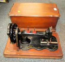 A cased Bradbury Company Limited Wellington Works Oldham sewing machine.