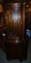 Two mahogany corner cabinets.