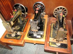 Two Singer sewing machines, and another, lacking cases. (3)