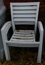Three white metal garden chairs.