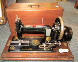 A cased J Shoolbred and Co sewing machine.