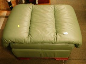 A green leather pouffe or footstool, 44cm high. The upholstery in this lot does not comply with the