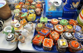 A quantity of Japanese condiment pots and covers, of differing design and colour way. (2 trays and l