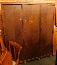 An early 20thC oak and inlaid triple wardrobe, 187cm high, 155cm wide, 54cm deep.