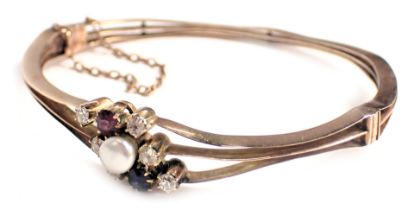 A hinged bangle, of three splay design, set with tiny diamonds, ruby, sapphire and cultured pearl, e