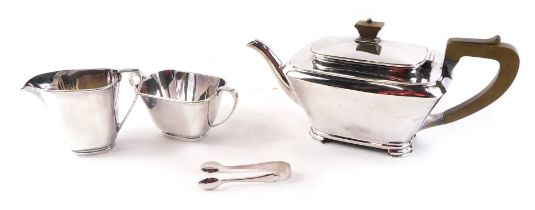 An Art Deco silver plated rectangular three piece tea set, with composition handle.